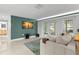 Bright living room featuring double doors to the outside, and view of the kitchen with modern lighting at 320 Lake Maggiore S Blvd, St Petersburg, FL 33705