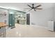 Open-concept living room flowing into an updated kitchen with green cabinets and a ceiling fan at 320 Lake Maggiore S Blvd, St Petersburg, FL 33705