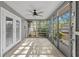 Enclosed sunroom with lots of natural light, tile flooring, and access to the backyard at 320 Lake Maggiore S Blvd, St Petersburg, FL 33705