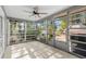 Enclosed sunroom with lots of natural light, tile flooring, and access to the backyard at 320 Lake Maggiore S Blvd, St Petersburg, FL 33705