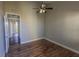 This bedroom features a ceiling fan, hardwood floors, and neutral walls at 3210 Mangrove Point Dr, Ruskin, FL 33570