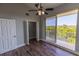 Bedroom with wood floors, walk-in closet, and a balcony offering lovely outdoor views at 3210 Mangrove Point Dr, Ruskin, FL 33570