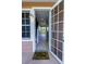 Inviting condo entrance featuring an open door and a welcoming 'hello' mat at 3210 Mangrove Point Dr, Ruskin, FL 33570