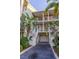 Shot of a beautiful condo complex exterior with tropical landscaping and private garages at 3210 Mangrove Point Dr, Ruskin, FL 33570