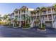 Condo complex exterior featuring private garages, stairways, and manicured landscaping at 3210 Mangrove Point Dr, Ruskin, FL 33570