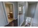 Open hallway with dark wood floors, leading to a powder room and stairway to the second floor at 3210 Mangrove Point Dr, Ruskin, FL 33570
