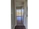 Hallway with wood floors, base trim, white doors, and views to the outside at 3210 Mangrove Point Dr, Ruskin, FL 33570