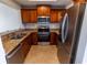 Kitchen with wooden cabinets, stainless steel appliances, and granite countertops at 3210 Mangrove Point Dr, Ruskin, FL 33570