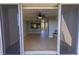 View of a well-lit living room with tile flooring and open access to the balcony at 3210 Mangrove Point Dr, Ruskin, FL 33570