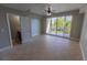 Bright living room featuring tile floors, ceiling fan, and sliding glass doors to a balcony with views at 3210 Mangrove Point Dr, Ruskin, FL 33570