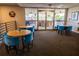 Comfortable community lounge area with tables, chairs, and access to outdoor seating at 3210 Mangrove Point Dr, Ruskin, FL 33570