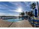 Sparkling community pool surrounded by lounge chairs and lush tropical landscaping at 3210 Mangrove Point Dr, Ruskin, FL 33570