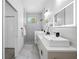 Modern bathroom featuring double vanity, elegant fixtures, and a walk-in shower at 3422 E Powhatan Ave, Tampa, FL 33610