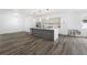 Bright and modern open-plan kitchen with updated appliances, large center island, and wood-look floors at 3422 E Powhatan Ave, Tampa, FL 33610