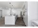 Bright open-concept kitchen with pendant lighting, stainless steel appliances, and a large center island at 3422 E Powhatan Ave, Tampa, FL 33610