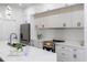 Bright kitchen showcases modern appliances, white cabinets, quartz countertops and stylish fixtures at 3422 E Powhatan Ave, Tampa, FL 33610