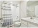 Bright bathroom features a shower-tub combo with a white shower curtain and modern fixtures at 35168 Arya Way, Zephyrhills, FL 33541