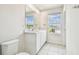 Bright bathroom featuring a double sink vanity, large mirror, and tiled flooring at 35168 Arya Way, Zephyrhills, FL 33541