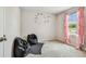 Bright bedroom with uplifting wall decor, pink curtains, and two plush beanbag chairs at 35168 Arya Way, Zephyrhills, FL 33541