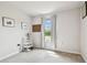 Bright bedroom with neutral carpet, a window with curtains, and decorative shelving at 35168 Arya Way, Zephyrhills, FL 33541