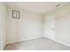 Simple bedroom featuring neutral carpet, a white door, and a single window for natural light at 35168 Arya Way, Zephyrhills, FL 33541