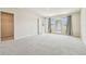 Spacious bedroom with neutral carpet, light walls, and large windows with gray curtains at 35168 Arya Way, Zephyrhills, FL 33541