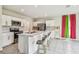 Modern kitchen featuring stainless steel appliances, white cabinetry, and a kitchen island with sink at 35168 Arya Way, Zephyrhills, FL 33541
