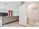Open concept living space featuring tile flooring, a comfortable gray sofa, and an adjacent half bathroom at 35168 Arya Way, Zephyrhills, FL 33541