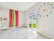 Bright living space featuring a large sliding glass door and unique decorative wall clock at 35168 Arya Way, Zephyrhills, FL 33541