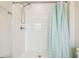 A clean, white-tiled shower with modern fixtures and a shower curtain at 35168 Arya Way, Zephyrhills, FL 33541