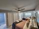 Bright bedroom with two beds, ceiling fan, closets, and marble floors, perfect for guests at 4119 W Nassau St, Tampa, FL 33607