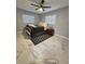 Inviting bedroom with marble flooring, a ceiling fan, and a cozy bed complemented by a decorative rug at 4119 W Nassau St, Tampa, FL 33607