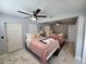 Bright bedroom with two beds, ceiling fan, and marble floors, perfect for guests at 4119 W Nassau St, Tampa, FL 33607