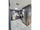 Modern kitchen features stainless steel appliances, custom gray cabinetry, and marble floors at 4119 W Nassau St, Tampa, FL 33607