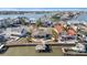Aerial view of a waterfront property featuring a private dock, a pool, and lush landscaping at 4544 Harbor Hills Dr, Largo, FL 33770