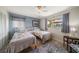 Bedroom featuring two twin beds, two windows offering nice lighting, and stylish decor at 4544 Harbor Hills Dr, Largo, FL 33770