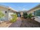 Inviting entrance with brick walkway and lush landscaping leading to a charming blue front door at 4544 Harbor Hills Dr, Largo, FL 33770