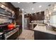 Modern kitchen with stainless steel appliances, dark wood cabinets, and tile backsplash at 4544 Harbor Hills Dr, Largo, FL 33770