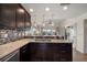 Open kitchen with granite countertops, stainless steel appliances, and decorative lighting at 4544 Harbor Hills Dr, Largo, FL 33770