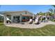 Expansive brick patio with comfortable seating and sunny backyard, perfect for outdoor gatherings and relaxation at 4544 Harbor Hills Dr, Largo, FL 33770
