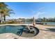 Waterfront pool area featuring a seating area and beautiful landscaping at 4544 Harbor Hills Dr, Largo, FL 33770