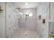 Luxurious marble tiled shower with rainfall showerhead and modern fixtures at 4544 Harbor Hills Dr, Largo, FL 33770