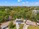 Aerial view of the property showcasing its surroundings and mature trees at 4613 Irene Loop, New Port Richey, FL 34652