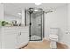 Modern bathroom with a glass door shower and vanity with black fixtures at 4613 Irene Loop, New Port Richey, FL 34652