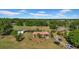 Scenic aerial shot of a home with lush greenery, outbuildings, and a peaceful countryside setting at 4615 Keene Rd, Plant City, FL 33565