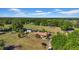 Picturesque aerial view showcasing a sprawling property with mature trees, lush lawns, and outbuildings at 4615 Keene Rd, Plant City, FL 33565