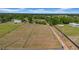 Aerial view of a spacious, fenced property with mature trees and road access, perfect for development at 4615 Keene Rd, Plant City, FL 33565