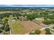 High angle aerial view showcasing an expansive landscape with a home and agricultural fields nearby at 4615 Keene Rd, Plant City, FL 33565