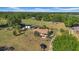Aerial view of the property featuring a single-story home with an tile roof and surrounding trees at 4615 Keene Rd, Plant City, FL 33565