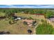 Aerial view of property featuring a well-maintained home and outbuildings set on a sprawling lot, shown with boundary lines at 4615 Keene Rd, Plant City, FL 33565